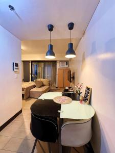 a living room with a table and a couch at Kai cabins NAIA 3 walking distance Newport City Pasay in Manila