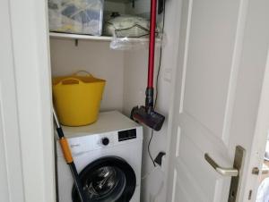 a mop sitting on top of a washing machine at gite dans une maison en rez-de-chaussée avec piscine in Joyeuse