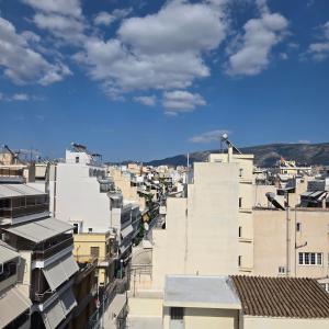 an aerial view of a city with buildings at Acropolis View Sky Suite with Jacuzzi near Metro in Athens