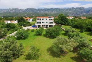 an aerial view of a house with a yard with trees at Apartments Vila Ana in Seline