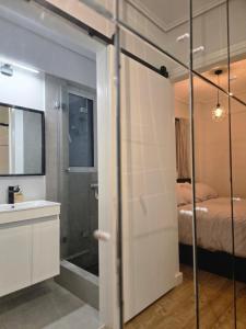 a bathroom with a shower and a bed and a sink at Acropolis View Sky Suite with Jacuzzi near Metro in Athens +35 photos