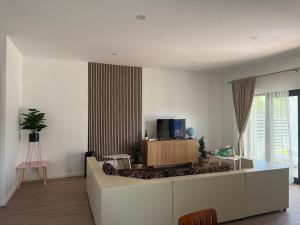 a living room with a couch and a tv at Luxury Villa Residence Corbeanca in Corbeanca