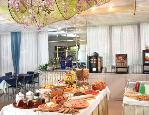 a buffet with many plates of food on a table at Hotel Acquamarina in Bellaria-Igea Marina