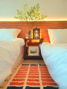 Postel nebo postele na pokoji v ubytování J&J Garden Stay Suncheon Bay National Garden Fair