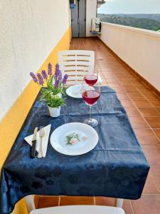 a table with two glasses of wine on a balcony at El ático de María in Ruidera +106 photos