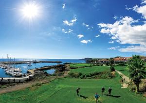 a group of people playing golf on a golf course at Velero Passionetenerife in San Miguel de Abona