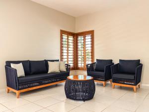 a living room with two couches and a coffee table at Mansão Beberibe in Beberibe