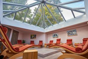 an empty waiting room with chairs and skylights at Hotel Weiss in Angermünde