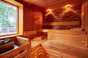 a sauna with wooden walls and a window at Hotel Weiss in Angermünde +11 photos