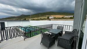 a balcony with two chairs and a table on a balcony at AkbA-Frame4 in İsmayıllı