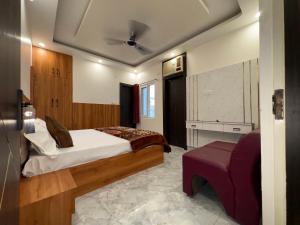 a bedroom with a bed and a couch in it at The Golden Inn in Lucknow