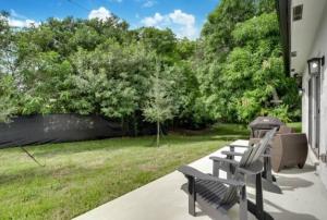 a group of benches sitting on the porch of a house at Modern 3BED 2BATH House in Fort Lauderdale in Fort Lauderdale
