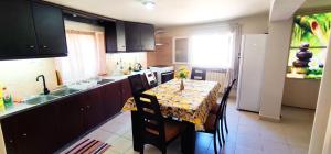 a kitchen with a table and chairs and a kitchen with a table and a kitchen at Regina house in Metaxáta