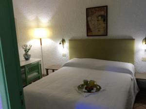 a bedroom with a bed with a bowl of fruit on it at Villa Eleanto in Cefalù