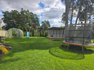 a yard with a playground and a gazebo at Paralepa Guest House in Haapsalu