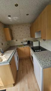 a kitchen with a sink and a counter top at Studio Flat - 5 mins from Manchester Airport in Baguley