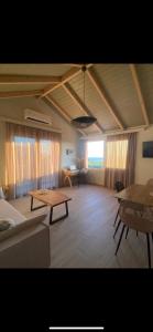 a living room with a couch and a table at Fiskouri Anthem in Preveza