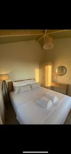 a large white bed with two towels on it at Fiskouri Anthem in Preveza