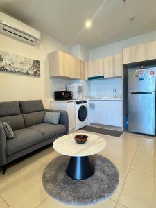 a living room with a couch and a table at The Shore Kota Kinabalu by Ems Executive Suites Seaview in Kota Kinabalu