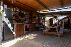 an outdoor kitchen with a refrigerator and a table at The Baja Station in San José del Cabo