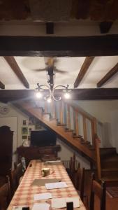 a dining room with a long table and a staircase at FARM-AgriHotel in Certosa di Pavia +27 photos