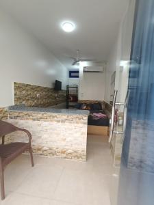 a living room with a stone wall and a couch at New El Amin Guesthouse in Aswan
