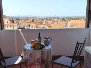 a table with a plate of fruit and a bottle of wine at Monte Longu in Sassari