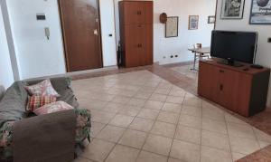 a living room with a couch and a flat screen tv at Monte Longu in Sassari