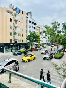 a busy city street with cars and people crossing the street at Rara HM in Male City +21 photos