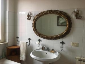 a bathroom with a sink and a mirror at Villino Luce in Nettuno +35 photos