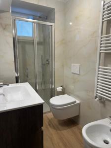 a bathroom with a shower and a toilet and a sink at Maison Simo in Pescasseroli +42 photos