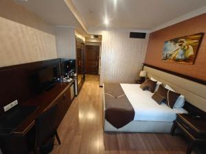 a hotel room with a bed and a desk at Smith Hotel in Baku