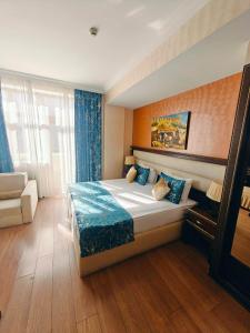 a bedroom with a bed and a couch in it at Smith Hotel in Baku +97 photos