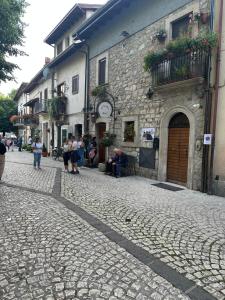 a group of people sitting outside of a building at Maison Simo in Pescasseroli