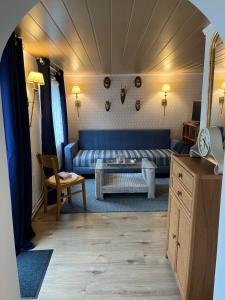 a living room with a couch and a table at Haus Almblick in Gasen