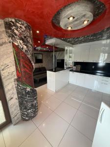 a large room with a stone pillar in a kitchen at LADA Apartment in Nesebar