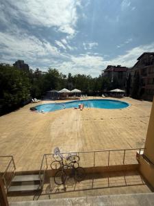 a bike parked in front of a swimming pool at LADA Apartment in Nesebar