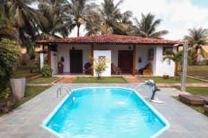 a swimming pool in front of a house at Pousada Aqualuna - São Miguel dos Milagres in São Miguel dos Milagres