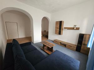 a living room with a couch and a table at Zámecký areál Dub in Dub