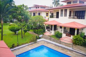 an aerial view of a house with a swimming pool at Wave 1 in Arpora