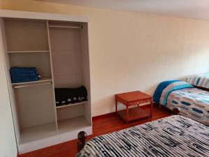 a bedroom with a bed and a book shelf at La Palmera in Chajarí