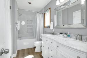 a white bathroom with a sink and a toilet at Jay bird landing escape #2308 in Big Bear City +21 photos