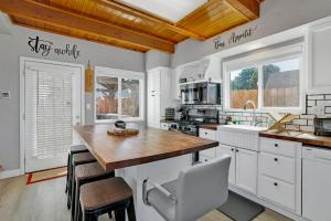 a kitchen with white cabinets and a wooden counter top at Jay bird landing escape #2308 in Big Bear City
