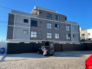 a car parked in front of a building at Casa Mar III in João Pessoa