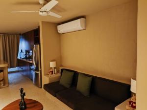 a living room with a couch and a refrigerator at Casa Gaviota in La Majahua