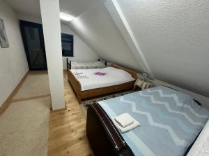 a small room with two beds and a staircase at Apartment Little Village in Plav