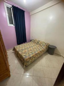 a bedroom with a bed in the corner of a room at Aghrod Boud in Tamri