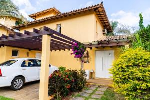 a white car parked in front of a house at Buzios VIP in Búzios
