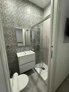 a bathroom with a toilet and a sink and a shower at The Collective Guesthouse in Sliema +43 photos