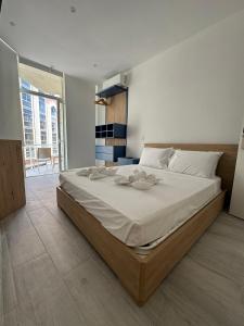 a bedroom with a large bed with white sheets at The Collective Guesthouse in Sliema